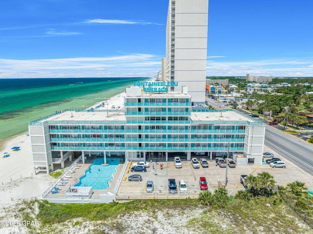 birds eye view of property featuring a view of the beach and a water view