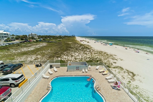 birds eye view of property with a water view and a view of the beach