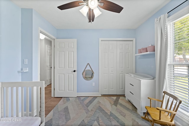 bedroom featuring a ceiling fan, a closet, and baseboards