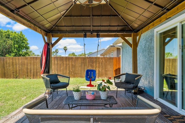 view of patio / terrace featuring fence, a deck, and a gazebo