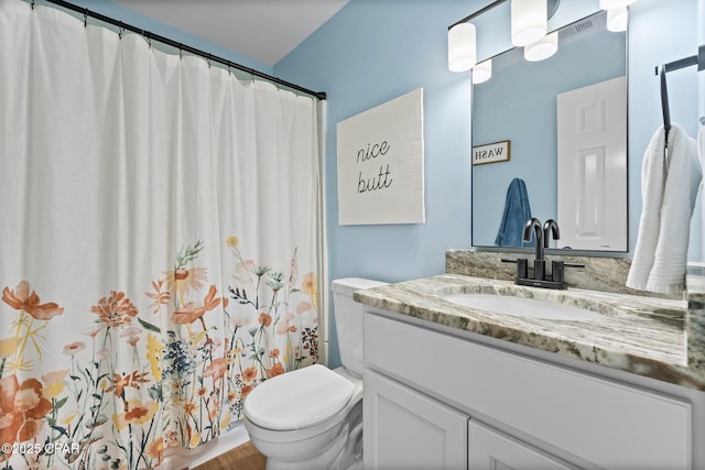 bathroom featuring visible vents, vanity, toilet, and a shower with curtain