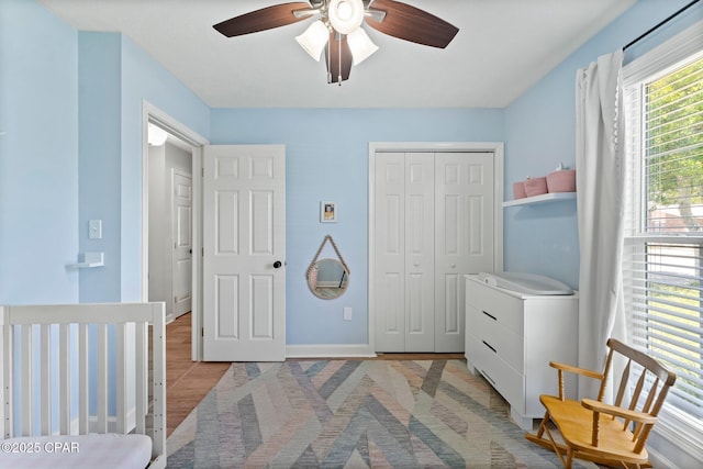 bedroom with a closet, a ceiling fan, and baseboards