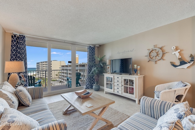 tiled living area with floor to ceiling windows and a textured ceiling