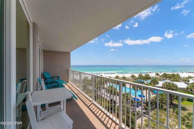 balcony featuring a water view and a beach view