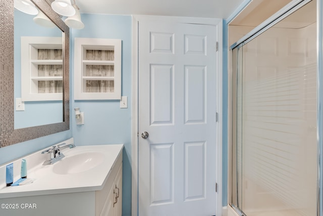 bathroom featuring built in features, a stall shower, and vanity