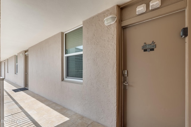 doorway to property with stucco siding