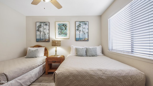 bedroom featuring wood finished floors and a ceiling fan