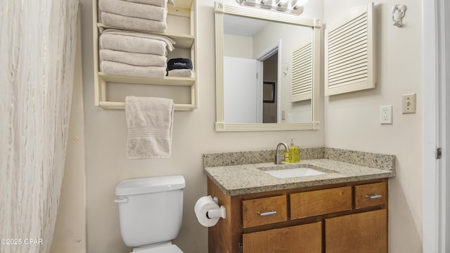 bathroom with toilet and vanity