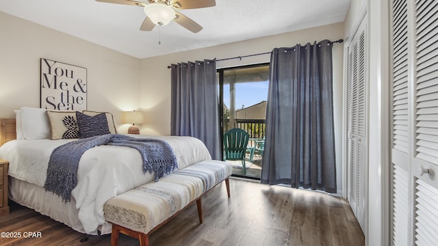 bedroom featuring ceiling fan, two closets, wood finished floors, and access to outside