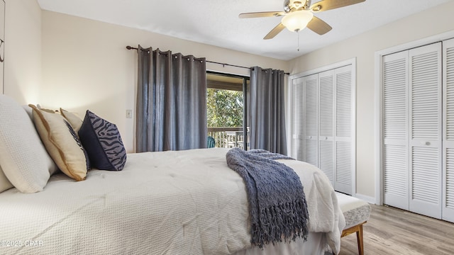 bedroom with multiple closets, light wood-style floors, a ceiling fan, and access to outside