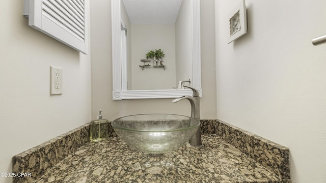 bathroom featuring a textured ceiling and a sink