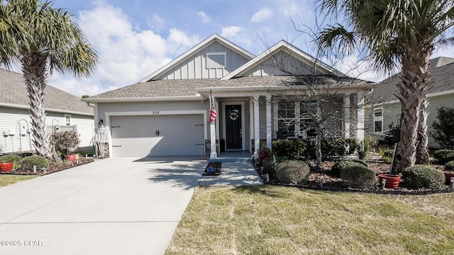 view of front of property featuring board and batten siding, concrete driveway, a garage, and a front yard