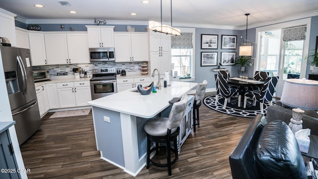 kitchen featuring a sink, tasteful backsplash, stainless steel appliances, crown molding, and light countertops