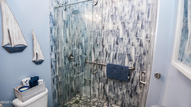 full bathroom featuring a stall shower and toilet