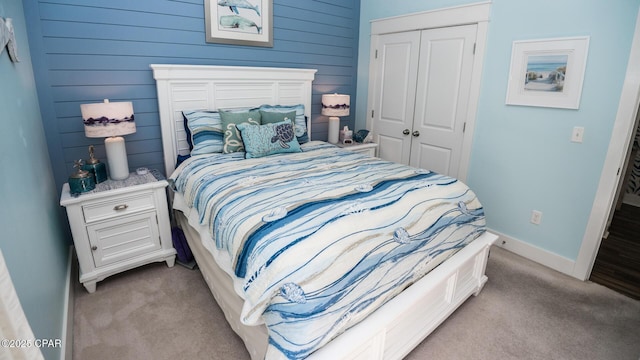 bedroom featuring baseboards, a closet, and carpet floors