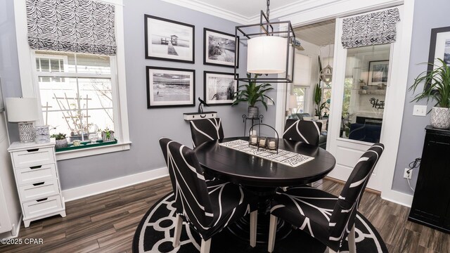 dining area featuring baseboards, dark wood-style flooring, and ornamental molding