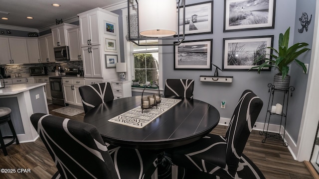 dining room featuring crown molding, dark wood-type flooring, baseboards, a toaster, and recessed lighting