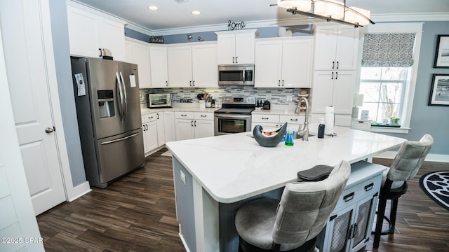 kitchen with dark wood finished floors, decorative backsplash, stainless steel appliances, and ornamental molding