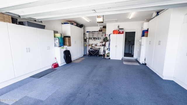 garage featuring a garage door opener and freestanding refrigerator