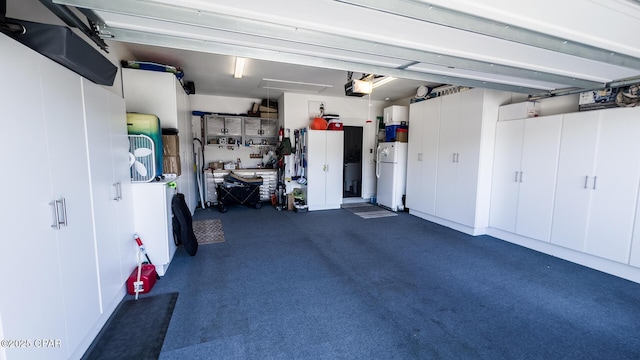 garage featuring a garage door opener and freestanding refrigerator