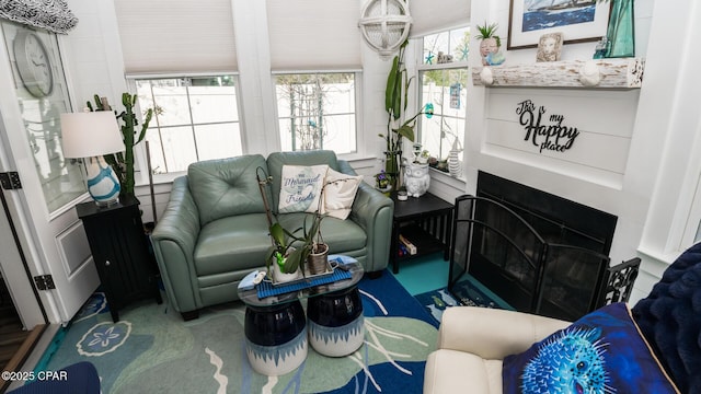 living area featuring a fireplace with flush hearth