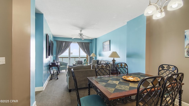 carpeted dining area featuring a ceiling fan and baseboards