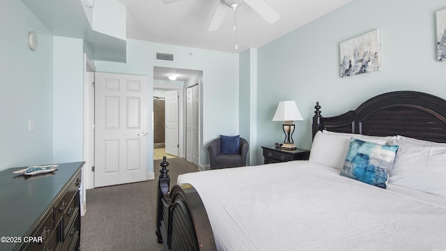 bedroom featuring visible vents, a closet, ceiling fan, and dark carpet