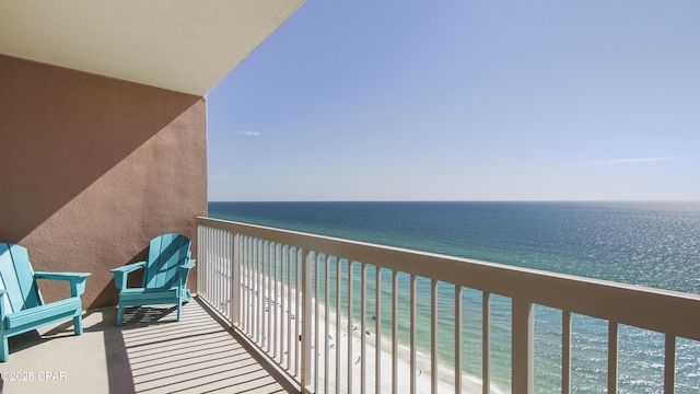 balcony featuring a beach view and a water view