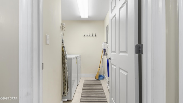 laundry area featuring light tile patterned floors, baseboards, independent washer and dryer, and laundry area