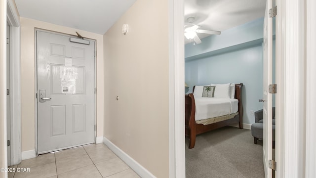 hall with light tile patterned floors and baseboards