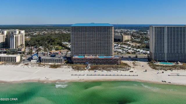 bird's eye view with a water view, a view of city, and a view of the beach