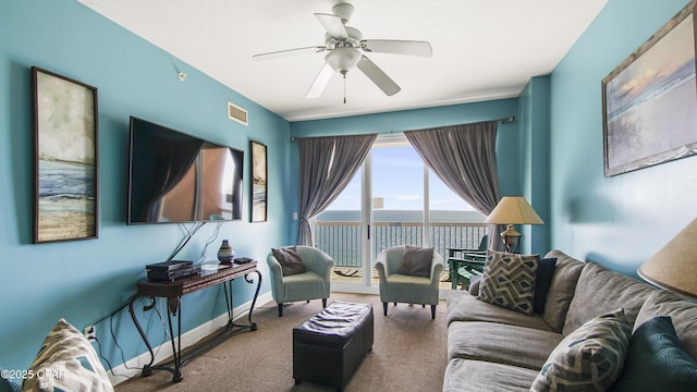 carpeted living room with visible vents, a ceiling fan, and baseboards