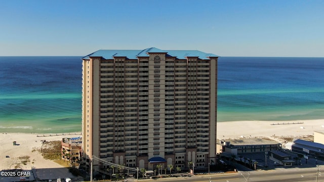 view of property featuring a view of the beach and a water view