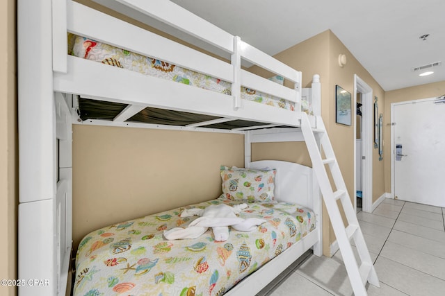 bedroom featuring light tile patterned floors and visible vents