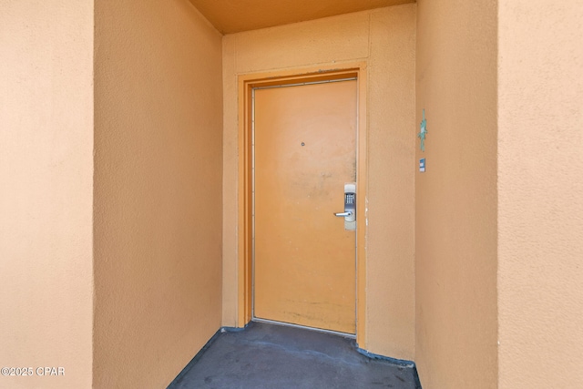 view of exterior entry with stucco siding