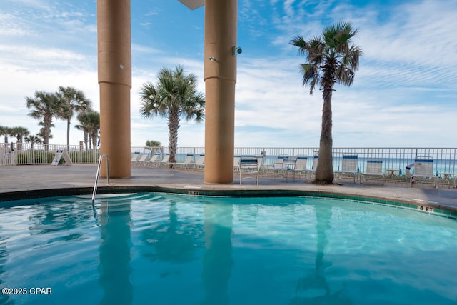 community pool featuring a patio and fence