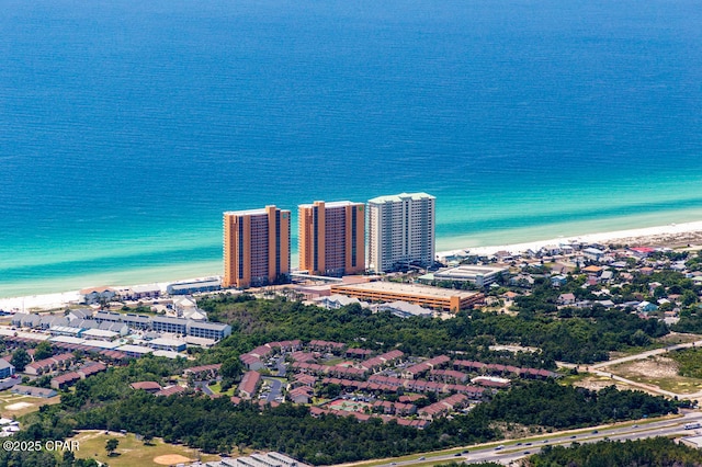 drone / aerial view with a view of city, a water view, and a beach view