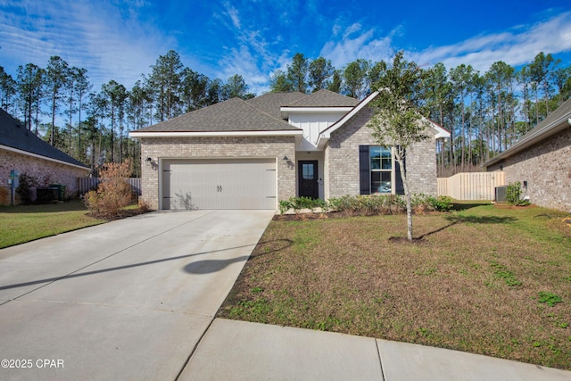 38 Cozy Cv, Freeport, FL 32439 - view of front of property with fence, an attached garage, concrete driveway, a front yard, and brick siding