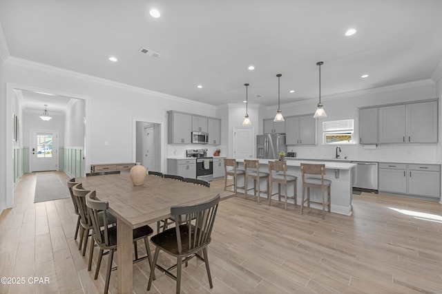 38 Cozy Cv, Freeport, FL 32439 - dining room featuring ornamental molding, visible vents, recessed lighting, and light wood finished floors