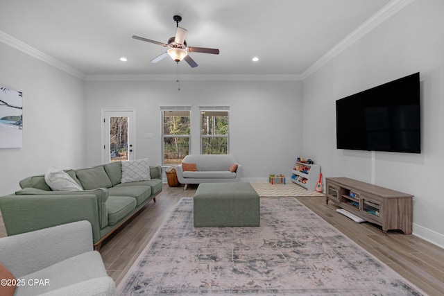 38 Cozy Cv, Freeport, FL 32439 - living room with ornamental molding, baseboards, light wood-style floors, and ceiling fan