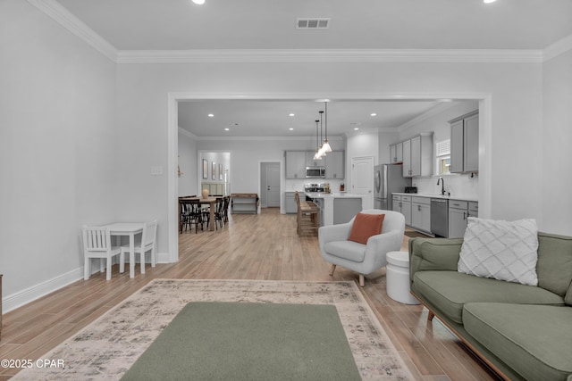 38 Cozy Cv, Freeport, FL 32439 - living area with light wood-type flooring, baseboards, visible vents, ornamental molding, and recessed lighting