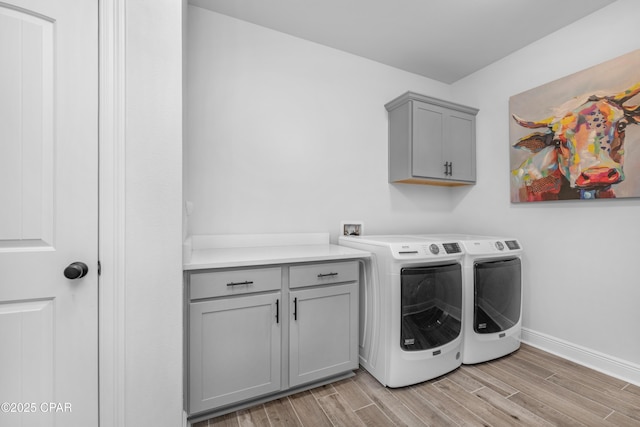 38 Cozy Cv, Freeport, FL 32439 - washroom with wood finish floors, cabinet space, washing machine and dryer, and baseboards