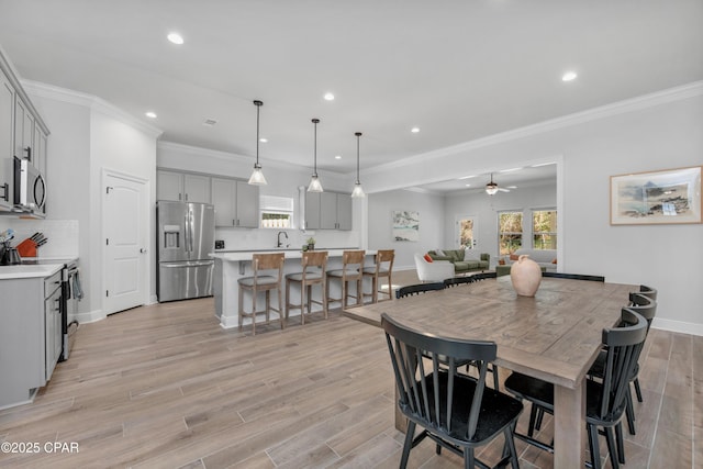 38 Cozy Cv, Freeport, FL 32439 - dining area with crown molding, baseboards, ceiling fan, recessed lighting, and light wood-type flooring