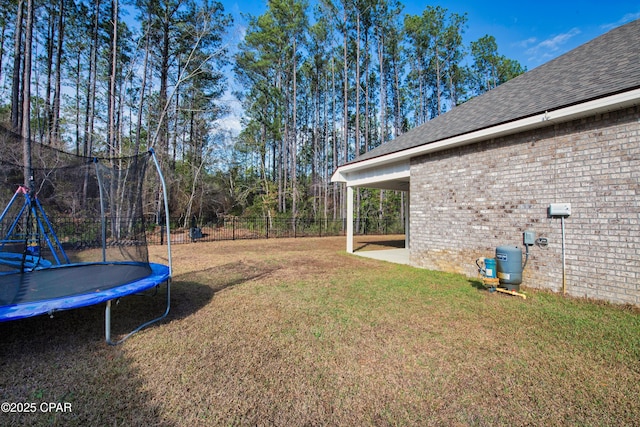 38 Cozy Cv, Freeport, FL 32439 - view of yard featuring a trampoline, fence, and a patio area