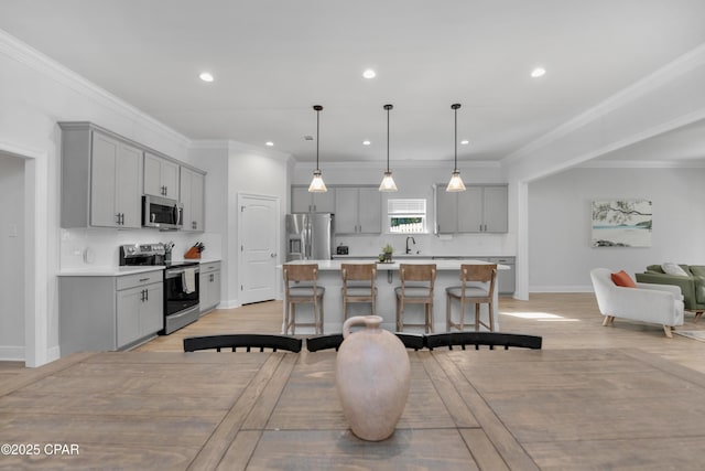 38 Cozy Cv, Freeport, FL 32439 - kitchen featuring light countertops, a center island, gray cabinetry, decorative backsplash, and appliances with stainless steel finishes