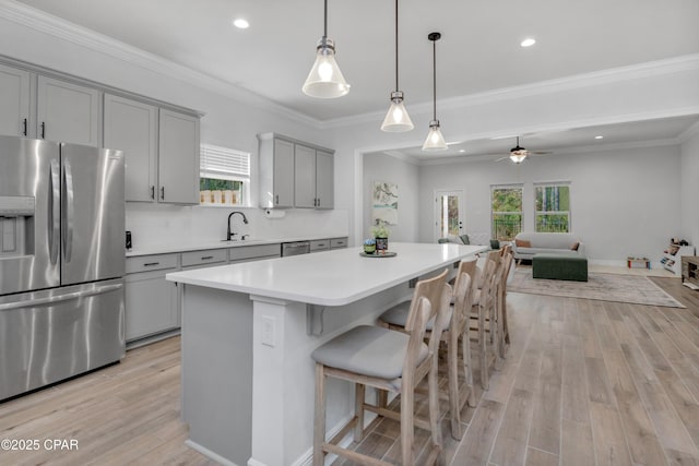 38 Cozy Cv, Freeport, FL 32439 - kitchen featuring open floor plan, light wood-type flooring, a center island, gray cabinetry, and appliances with stainless steel finishes