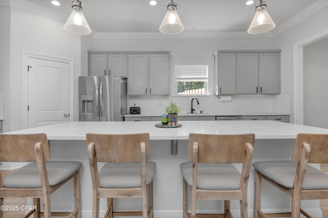 38 Cozy Cv, Freeport, FL 32439 - kitchen with stainless steel fridge, gray cabinets, a center island, backsplash, and a sink