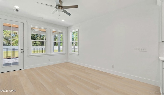 spare room featuring a ceiling fan, visible vents, baseboards, recessed lighting, and light wood-style floors