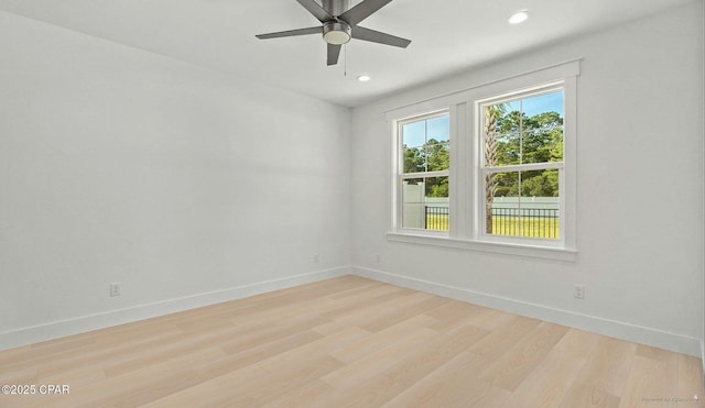 spare room with light wood finished floors, recessed lighting, baseboards, and ceiling fan