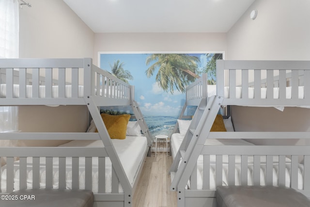 bedroom featuring vaulted ceiling and wood finished floors